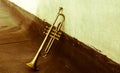 An ancient Jazz trumpet of the 30s leaning against the wall Royalty Free Stock Photo