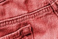 Old jeans texture close up, top view. Denim background, red color toned Royalty Free Stock Photo