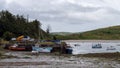 An old jetty and several moored fishing boats in Clonakilty Bay. Fishing boats anchored at low