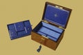 Old jewelry box with compartments on blue velvet Royalty Free Stock Photo