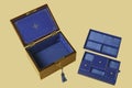 Old jewelry box with compartments on blue velvet Royalty Free Stock Photo