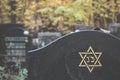 Old jewish cemetery, funeral and burial of a Jew. A grave with a stone with hexagram