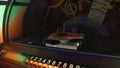 Old jukebox automatically playing selected musical records in pub, retro party