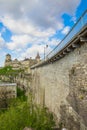 Old Kamianets-Podilskyi Castle and stone bridge under the blue sky with white clouds. The fortress located among the picturesque Royalty Free Stock Photo