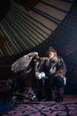 Old kazakh eagle hunter with his golden eagle Royalty Free Stock Photo