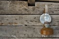 Old kerosene lamp hanging on a rustic wooden wall of a barn Royalty Free Stock Photo