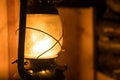 Old kerosene lamp hanging from a wooden beam