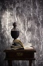 Old kerosene lamp and open book Royalty Free Stock Photo