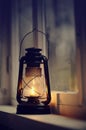 An old kerosene lamp stands on a white windowsill Royalty Free Stock Photo