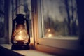 An old kerosene lamp stands on a white windowsill Royalty Free Stock Photo