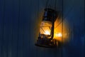 Old kerosene lantern hanging on the yellow wooden wall Royalty Free Stock Photo