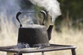 Old kettle boiling outdoors Royalty Free Stock Photo