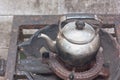 Old kettle on rusty gas stove