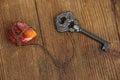 Old key and an amber keychain lies on an old wooden table, natural textures, a concept of discovery, secrets, answers, answers to