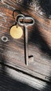 Old key with blank tag wooden background. Space for text. Rustic texture. Retro style. Vintage photo Royalty Free Stock Photo