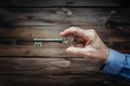 Old key held by mans hand, vintage concept image Royalty Free Stock Photo