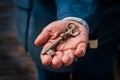 Old key held by mans hand, vintage concept image Royalty Free Stock Photo