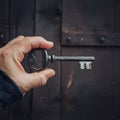 Old key held by mans hand, vintage concept image Royalty Free Stock Photo