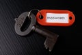 An old key with an inscription on a black table. Accessories and symbol referring to the word in the description of the key Royalty Free Stock Photo