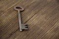 Old key lies on an old wooden table, natural textures, the concept of discovery, secrets, answers, answers to difficult questions Royalty Free Stock Photo