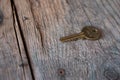 Inheritance concept: Old key is lying on rustic wooden desk Royalty Free Stock Photo