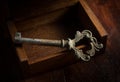 Old key on open wooden chest. Royalty Free Stock Photo