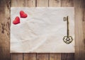 Old key and red heart on Old paper vintage on wood background with space Royalty Free Stock Photo