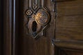 Old keyhole close up. Retro vintage wooden door with brass copper keyhole
