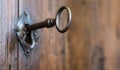 Old keyhole with key on a wooden antique door Royalty Free Stock Photo