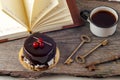 Old keys, book, cake with cup of tea on rustic wooden background. Royalty Free Stock Photo