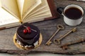 Old keys, book, cake with cup of tea on rustic wooden background. Royalty Free Stock Photo