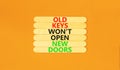 Old keys do not open new doors symbol. Concept words Old keys do not open new doors. Beautiful orange table orange background. Royalty Free Stock Photo