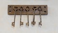 Old keys with key hanging on a white wall of an old hotel