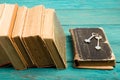 Old keys on a old book and stack of antique books on blue wooden