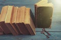 Old keys on a old book and stack of antique books on blue wooden Royalty Free Stock Photo