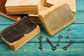 Old keys, stack of antique books on blue wooden background Royalty Free Stock Photo