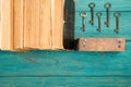 Old keys and stack of antique books on blue wooden desk Royalty Free Stock Photo