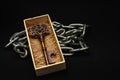 The old keys that were in a wooden box placed on a chain with a black background