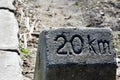 Old Kilometer stone says ` 2.0 KM.` to get into the destination. Royalty Free Stock Photo