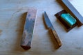 Old kitchen knives and whetstone. Sharpening stones and an old knife. Restoration of the knife