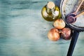 Old kitchen pan wooden spoon three onions carafe with olive oil on wooden table. Royalty Free Stock Photo