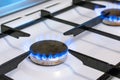 Old kitchen stove cook with blue flames burning. Possible leakage and gas poisoning. Household gas stove Royalty Free Stock Photo