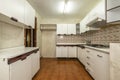 old kitchen with white wood-edged cabinets, white wood countertops and vintage tiles