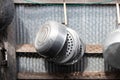 Old Kitchenware various sized metal pan pot hanging in row on hooks attached on wall galvanized sheet Royalty Free Stock Photo