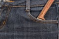 Old knife with a wooden handle in your pocket jeans. Royalty Free Stock Photo