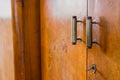 Old knob, lock and handles on an old wooden furniture. Visible also lock and a key on an old decayed wooden door Royalty Free Stock Photo