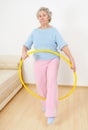 Old lady doing gymnastic with hula-hoop Royalty Free Stock Photo