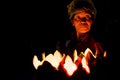 Old lady with face in candle light selling candles on the streets of the ancient town Hoian at night. Hoi An, Vietnam - 28/01/