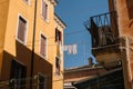 Old lady hangs freshly washed laundry to dry in the sun in Venice, Italy Royalty Free Stock Photo