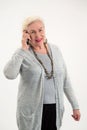 Old lady holding cell phone. Royalty Free Stock Photo